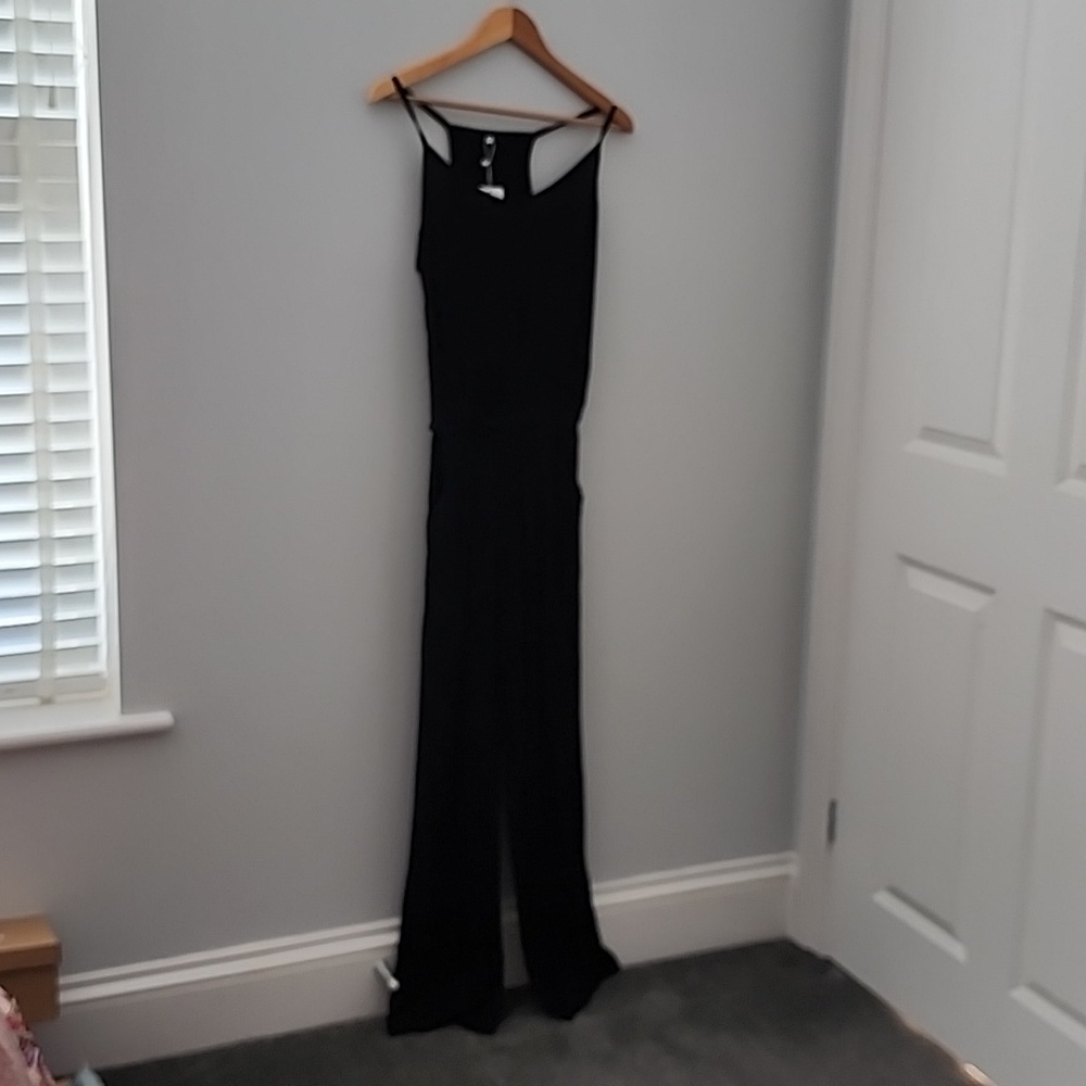 Black spaghetti strap wide leg jumpsuit romper with pockets.